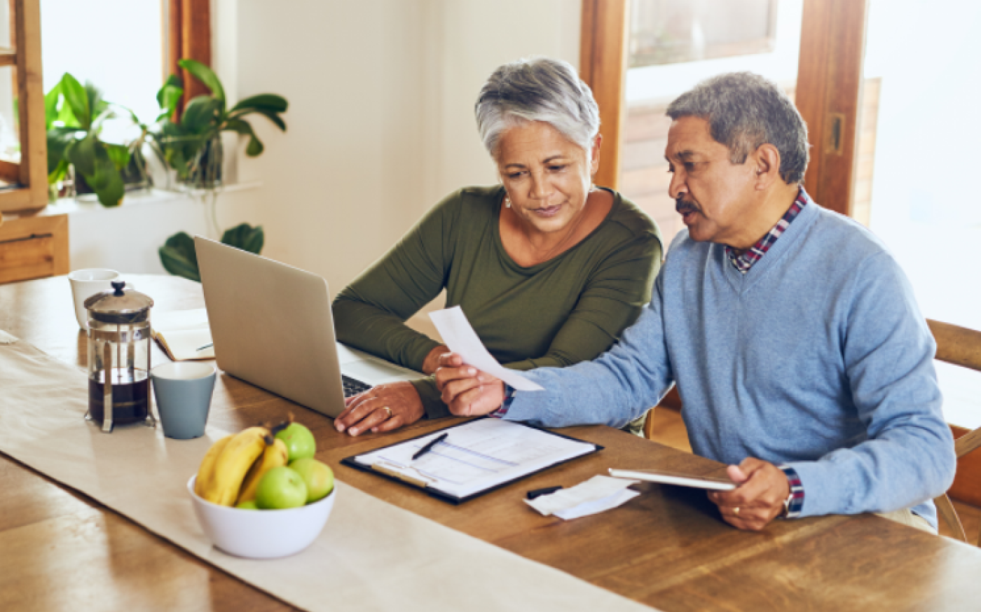 Couple sitting at table with laptop