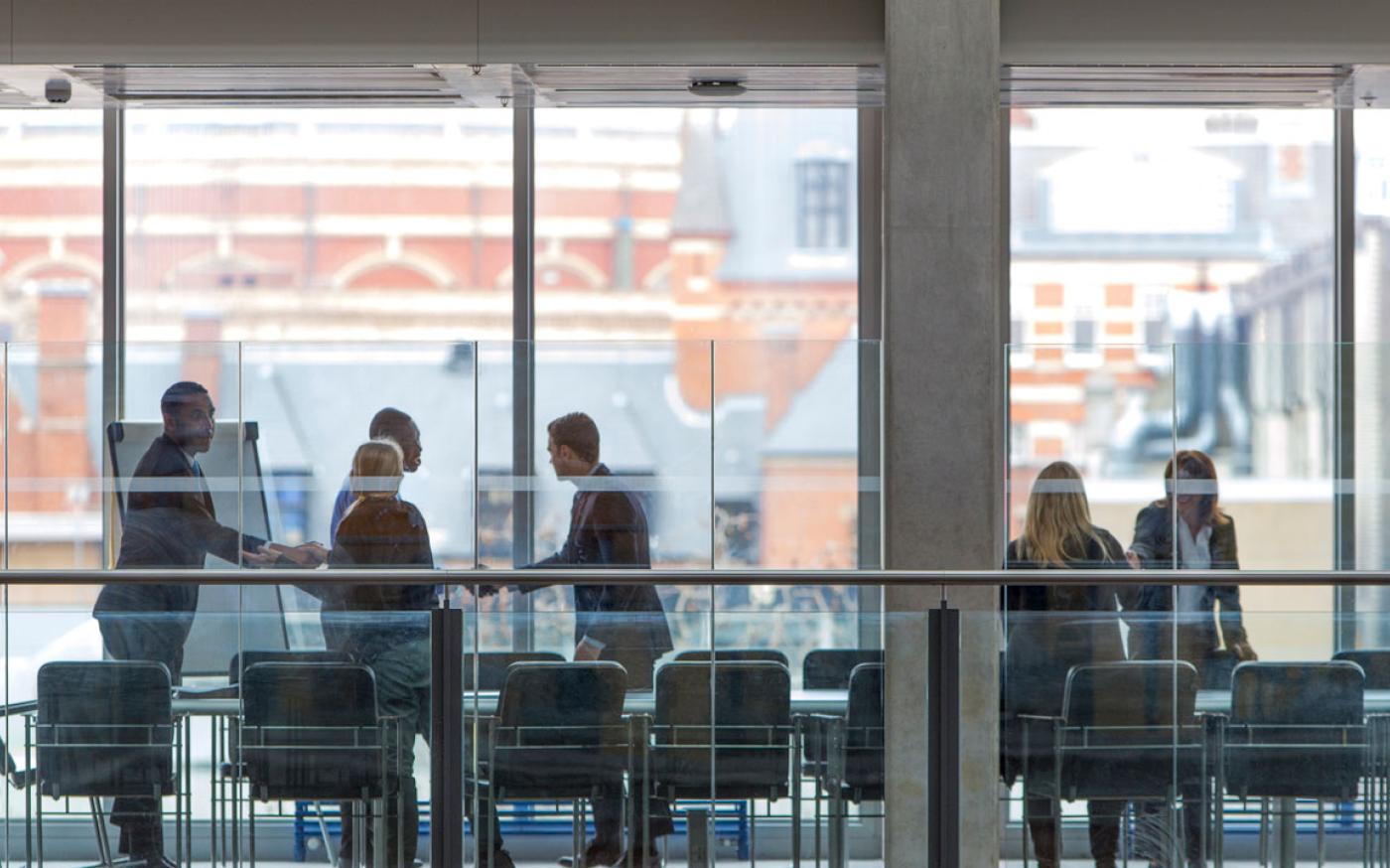 people-shaking-hands-in-a-boardroom